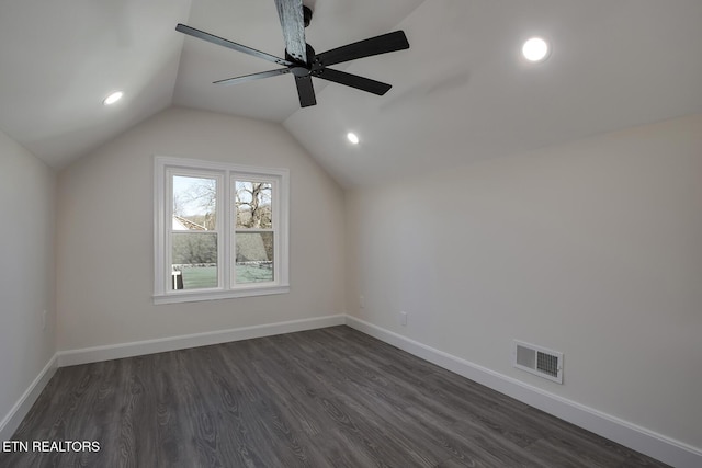 bonus room featuring visible vents, baseboards, lofted ceiling, and dark wood-style flooring