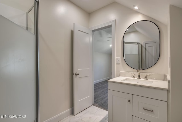 bathroom with a shower with shower door, baseboards, marble finish floor, and vanity