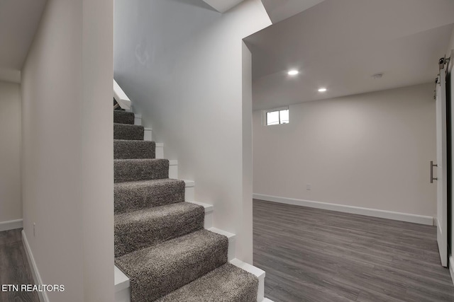 staircase with recessed lighting, baseboards, and wood finished floors