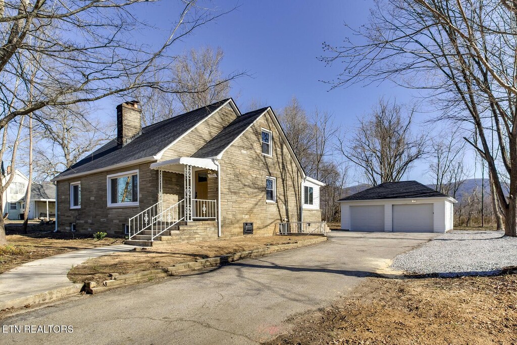 1131 Main St, Wartburg, TN 37887 - view of front of home featuring a garage, a chimney, and an outdoor structure