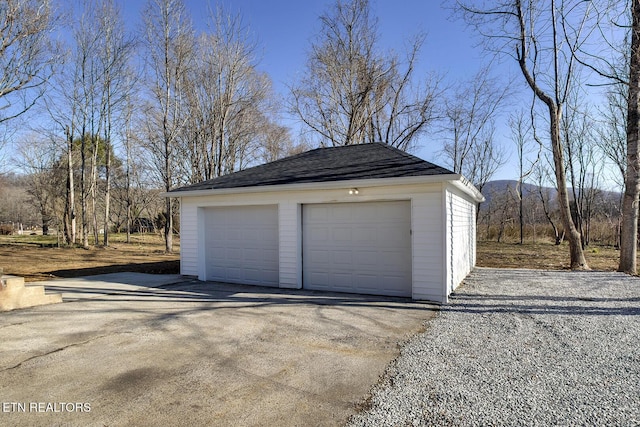 detached garage featuring a mountain view