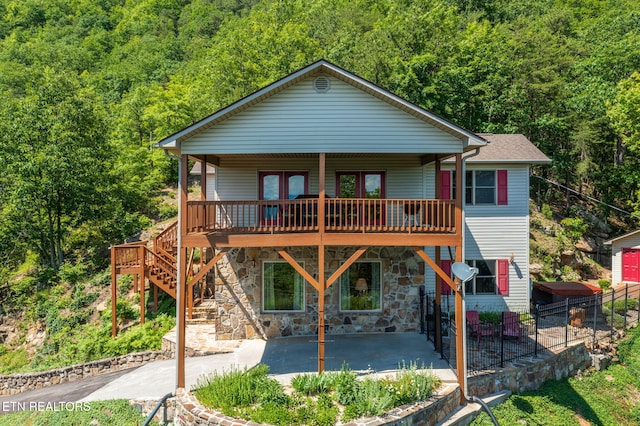 954 Pawnee Ct, Sevierville, TN 37876 - rear view of property with fence, a view of trees, a patio, stone siding, and stairway