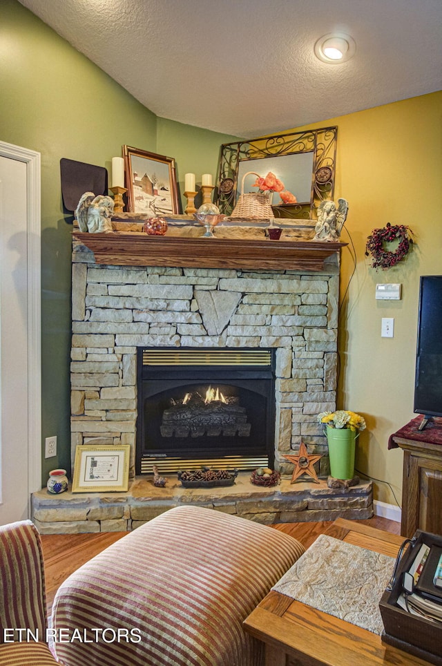 954 Pawnee Ct, Sevierville, TN 37876 - room details with a textured ceiling, a stone fireplace, and wood finished floors