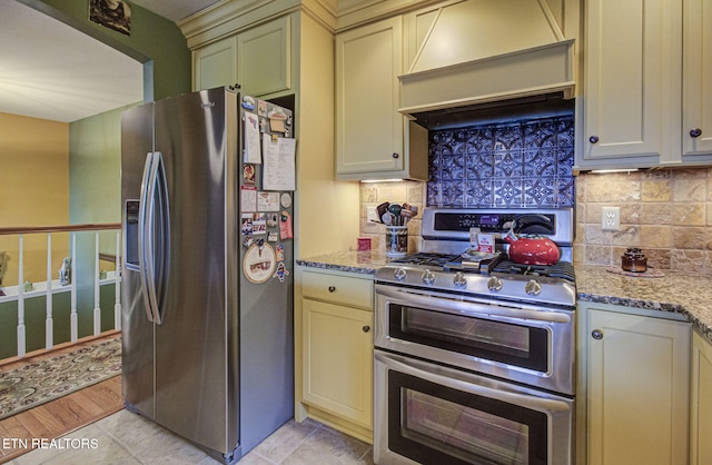 954 Pawnee Ct, Sevierville, TN 37876 - kitchen featuring cream cabinetry, stainless steel appliances, custom range hood, and backsplash