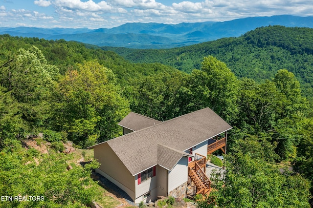 drone / aerial view with a mountain view and a wooded view