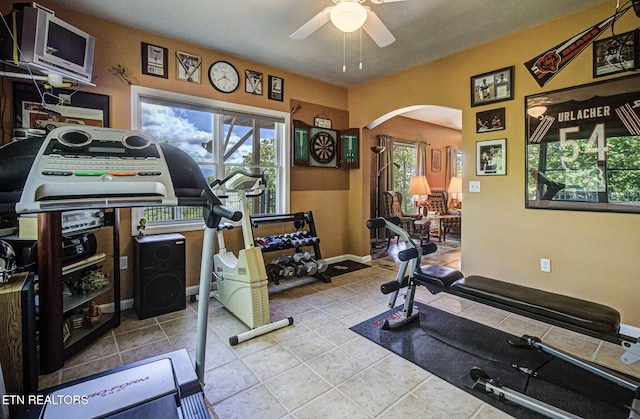 954 Pawnee Ct, Sevierville, TN 37876 - exercise area featuring tile patterned flooring, arched walkways, a ceiling fan, and baseboards