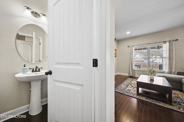 bathroom featuring baseboards and hardwood / wood-style floors