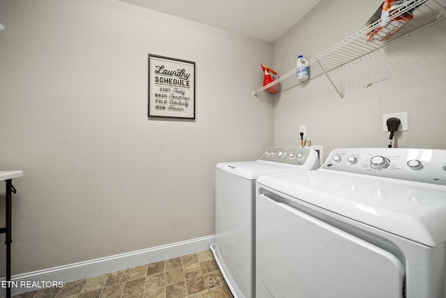 clothes washing area featuring laundry area, washing machine and dryer, and baseboards