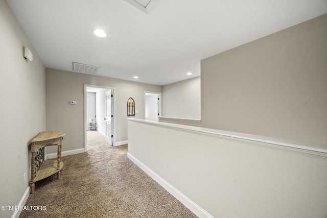 hallway with carpet, visible vents, baseboards, and recessed lighting