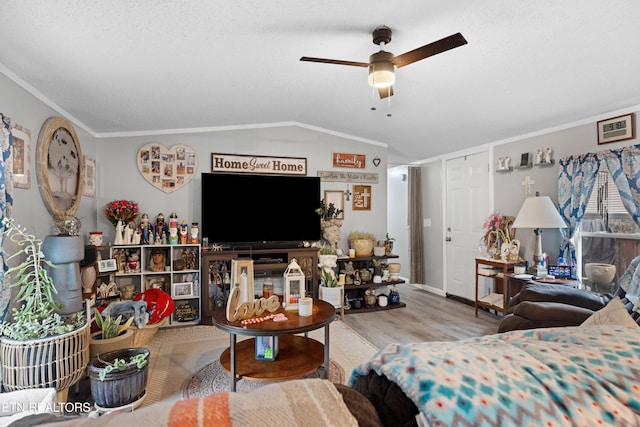 living room with lofted ceiling, ceiling fan, crown molding, and wood finished floors