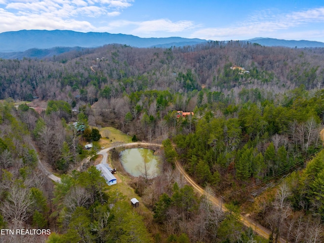 aerial view with a mountain view and a wooded view