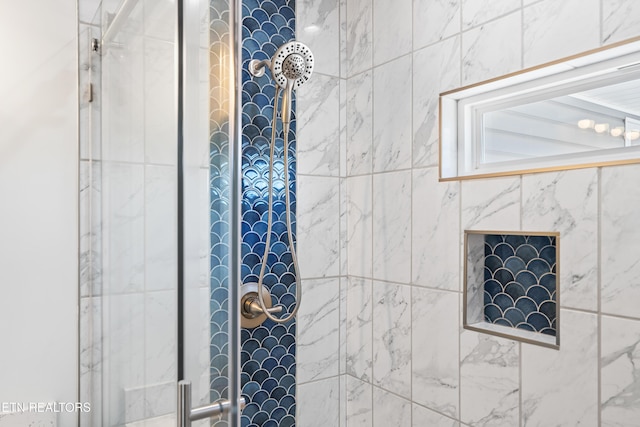bathroom with tiled shower