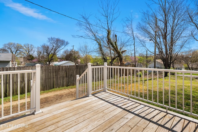 wooden terrace with fence and a yard