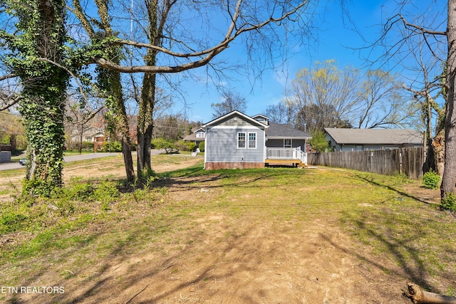 exterior space with fence and a yard