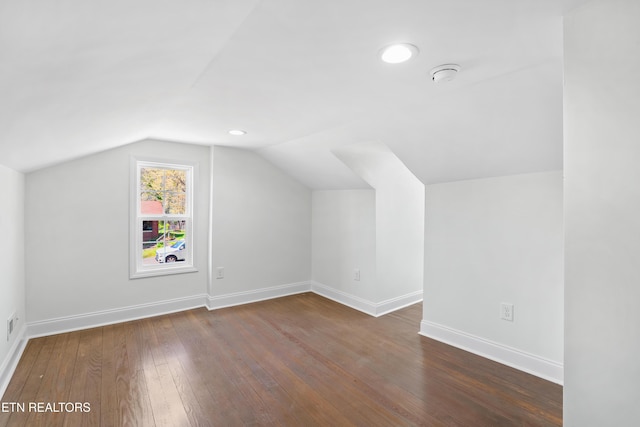 bonus room with recessed lighting, baseboards, vaulted ceiling, and dark wood finished floors