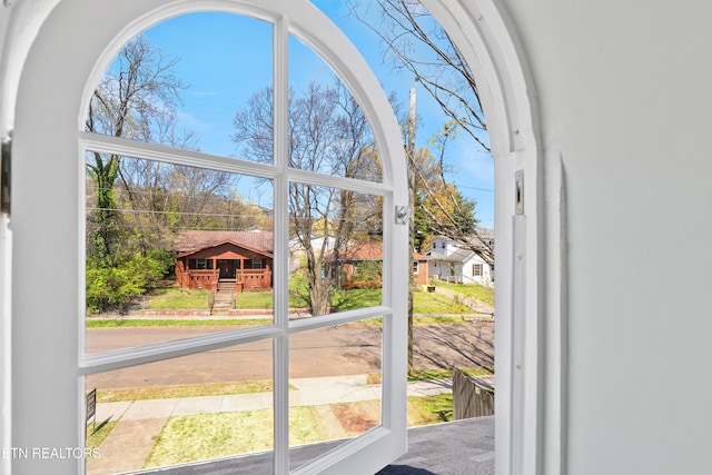 entryway with carpet and a residential view