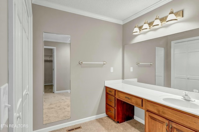 bathroom with a closet, vanity, visible vents, and crown molding