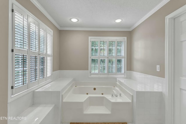 bathroom featuring a healthy amount of sunlight, crown molding, a textured ceiling, and a tub with jets