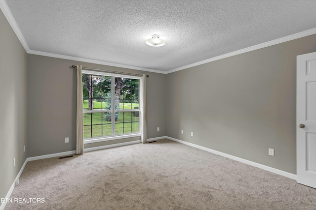 spare room with carpet, visible vents, baseboards, and crown molding