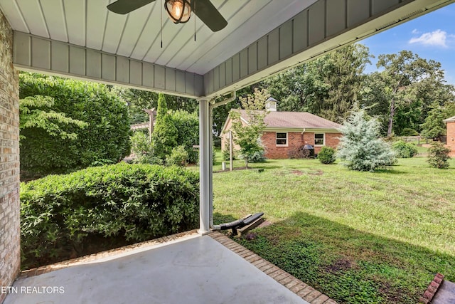 view of yard featuring a ceiling fan and a patio area