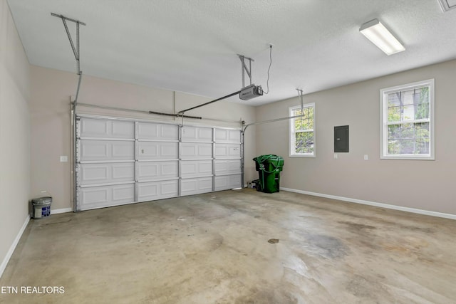 garage with baseboards, electric panel, and a garage door opener