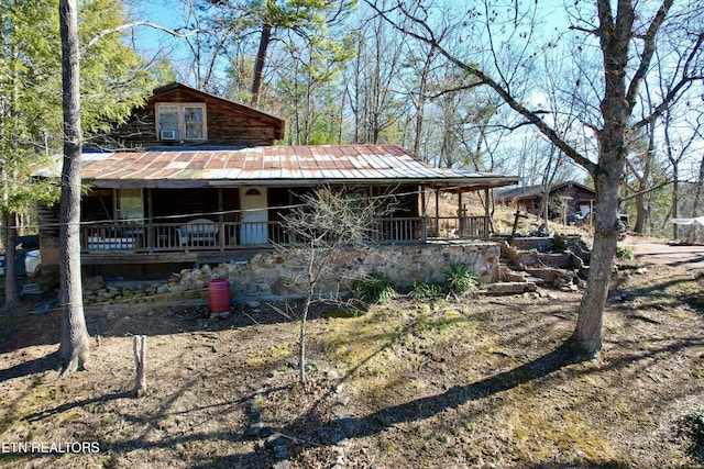 exterior space featuring a porch and metal roof