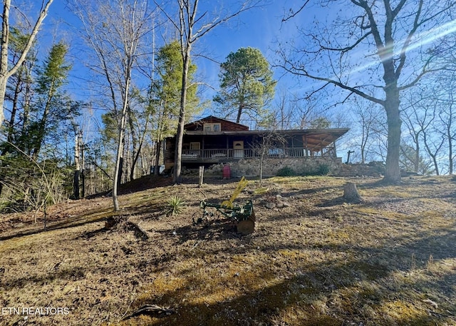 back of property featuring a porch