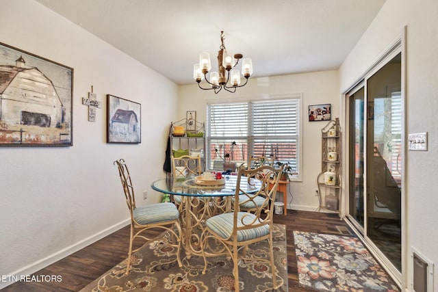 dining room with baseboards, an inviting chandelier, and wood finished floors