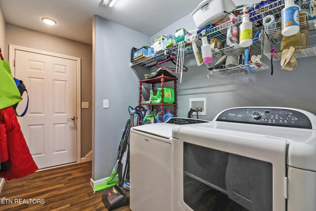 laundry area featuring washer and clothes dryer, laundry area, baseboards, and wood finished floors