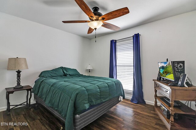 bedroom with wood finished floors, baseboards, and ceiling fan