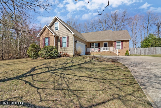 view of front of home with fence, concrete driveway, a front lawn, a garage, and brick siding