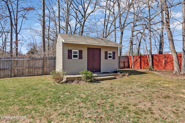 view of outdoor structure featuring an outbuilding and a fenced backyard