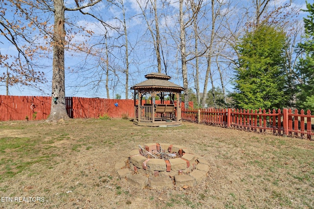 view of yard featuring a gazebo, a fire pit, and a fenced backyard