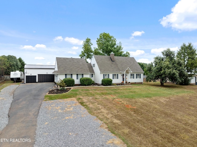 cape cod-style house featuring a chimney, a detached garage, and a front yard