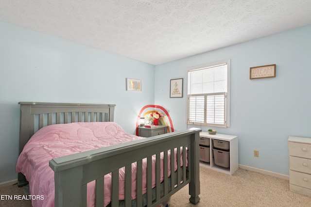 bedroom with baseboards, a textured ceiling, and light colored carpet