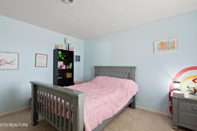 carpeted bedroom featuring baseboards