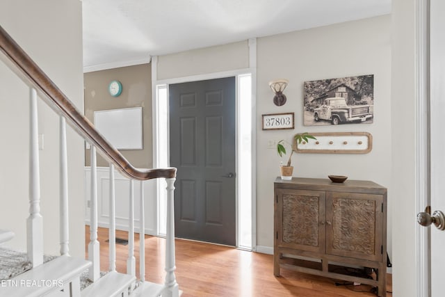 foyer entrance with stairway and wood finished floors