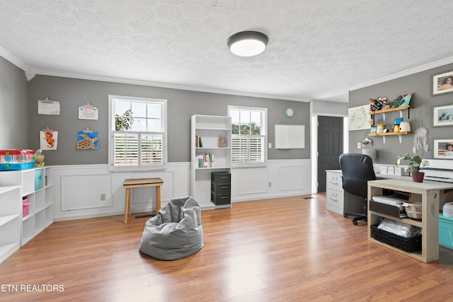 home office featuring wainscoting, crown molding, and wood finished floors