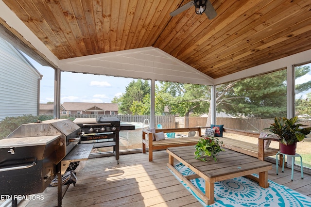 wooden deck with an outdoor hangout area and fence