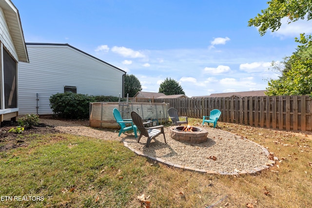 view of yard with fence and a fire pit