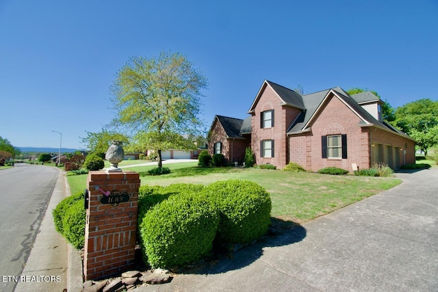 1689 Peppertree Dr, Alcoa, TN 37701 - traditional-style house featuring brick siding, a garage, a front lawn, and driveway