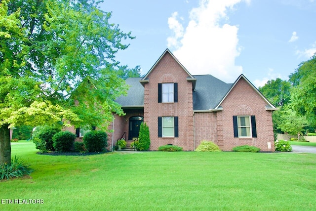 1689 Peppertree Dr, Alcoa, TN 37701 - traditional-style home with brick siding, a front lawn, and a shingled roof