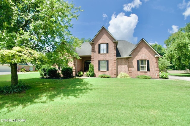 1689 Peppertree Dr, Alcoa, TN 37701 - traditional-style home featuring brick siding and a front lawn