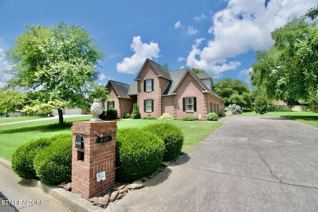 1689 Peppertree Dr, Alcoa, TN 37701 - traditional-style home with a front yard, brick siding, and a garage