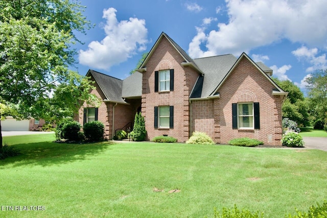 1689 Peppertree Dr, Alcoa, TN 37701 - traditional-style house with brick siding, a front lawn, and a shingled roof