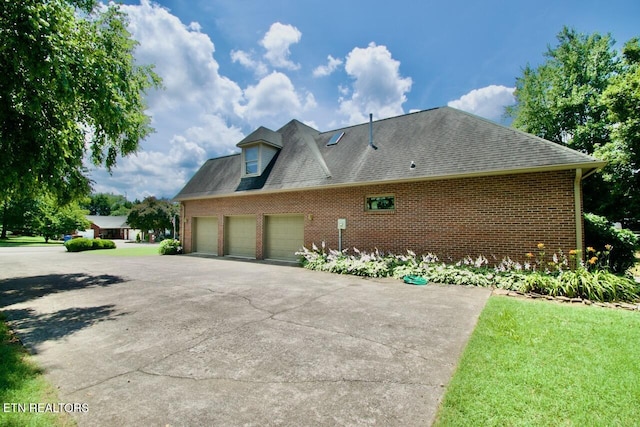 1689 Peppertree Dr, Alcoa, TN 37701 - view of side of property with brick siding, a shingled roof, driveway, and an attached garage