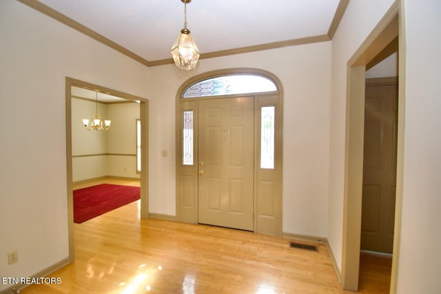 1689 Peppertree Dr, Alcoa, TN 37701 - entrance foyer with a chandelier, light wood finished floors, and ornamental molding