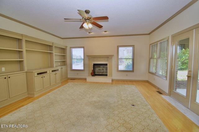 1689 Peppertree Dr, Alcoa, TN 37701 - unfurnished living room with light wood-style floors, ceiling fan, a glass covered fireplace, and ornamental molding