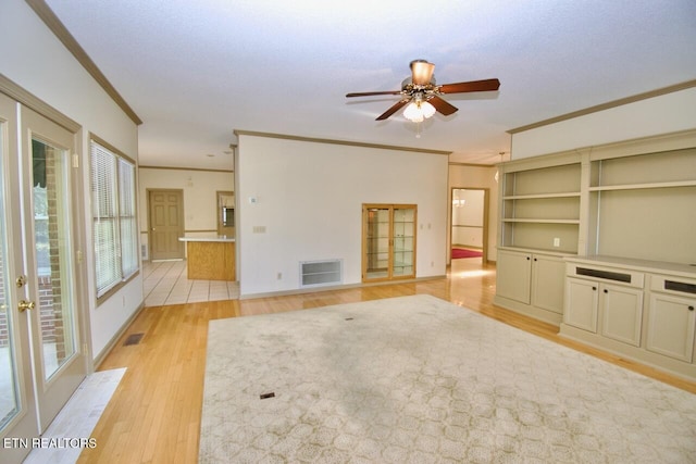 1689 Peppertree Dr, Alcoa, TN 37701 - unfurnished living room featuring ornamental molding, light wood-style floors, and a ceiling fan