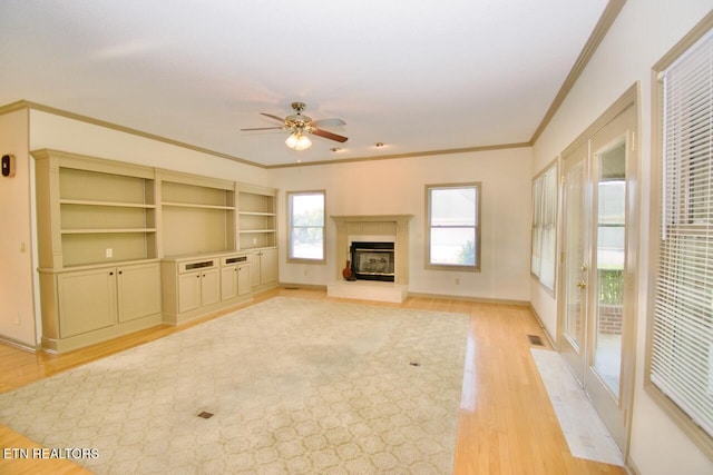 1689 Peppertree Dr, Alcoa, TN 37701 - unfurnished living room featuring ornamental molding, light wood finished floors, ceiling fan, and a glass covered fireplace